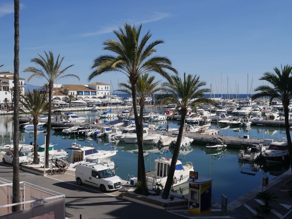 Sunny day at Puerto de la Duquesa, with boats and Mediterranean charm